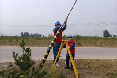 深入田間地頭為配電線路桿塔拉線安裝反光膜、拉線護套